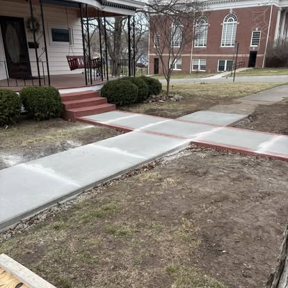 Front walkway leading to a porch with red trim