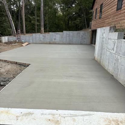 Concrete pad with retaining walls